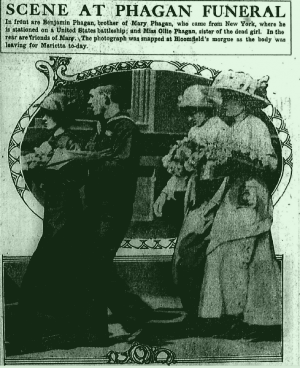 Scene at Phagan funeral. In front are Benjamin Phagan, brother of Mary Phagan, who came from New York, where he is stationed on a United States battleship; and Miss Ollie Phagan, sister of the dead girl. In the rear are friends of Mary. The photograph was snapped at Bloomfield's morgue as the body was leaving for Marietta to-day.